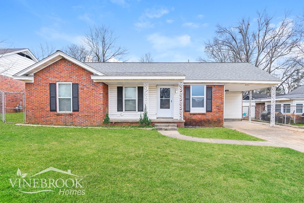A brick house with a white door and a sign that says Vinebrook Horne.