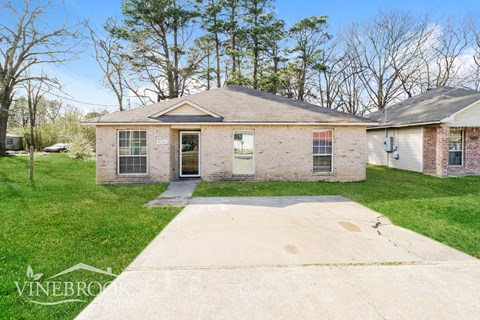 A house with a driveway in front of it.