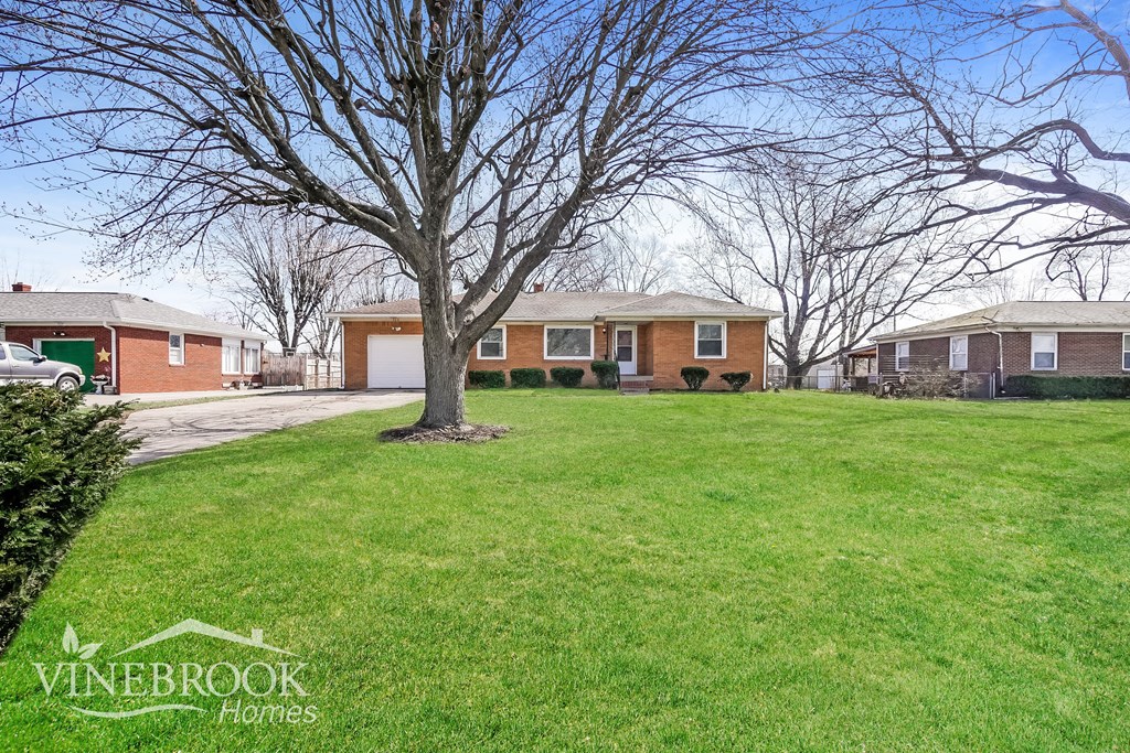 A Vinebrook Homes sign is in front of a green lawn.