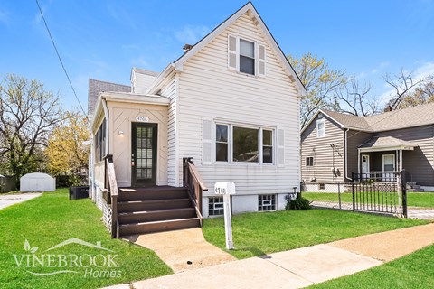 A two-story house with a front porch and a garage.