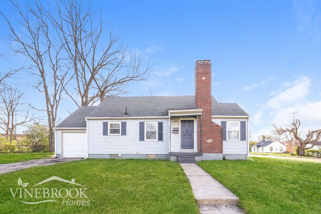 A house with a Vinebrook Homes sign in front of it.