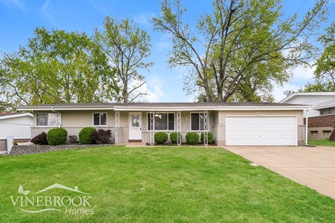 A house with a white garage door is for sale.