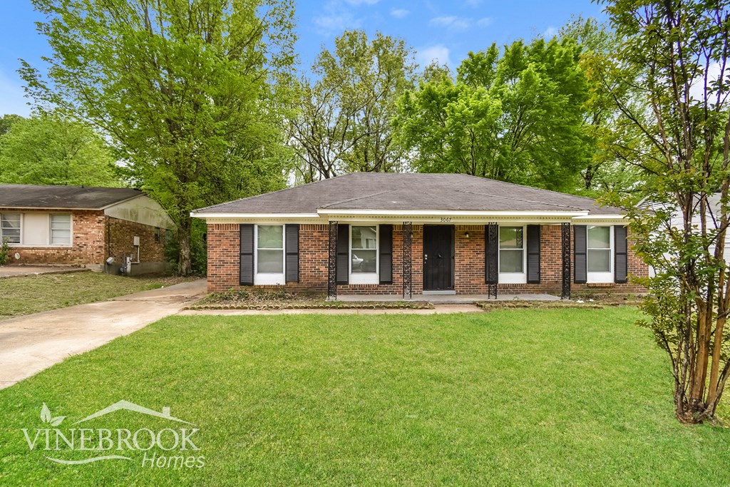 A house with a lawn in front of it.