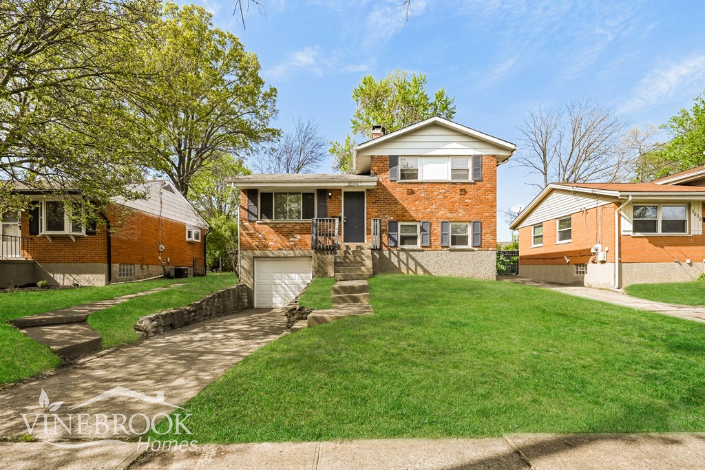 A house with a lawn in front of it.