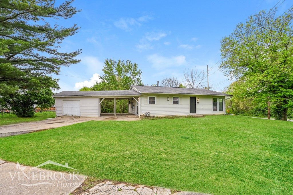 A house with a white garage door is for sale.