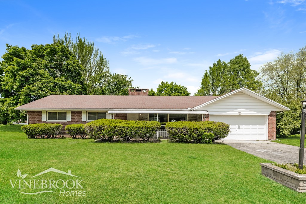 A house with a lawn in front of it and the words Vinebrook Homes on the bottom left.
