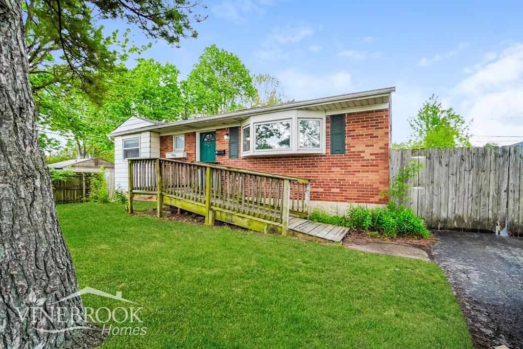A house with a green door and a wooden fence.