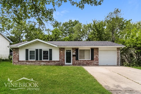 A house with a Vinebrook Homes sign in front of it.