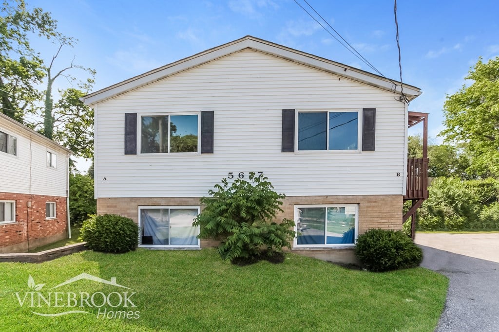 A house with a Vinebrook Homes sign in front of it.