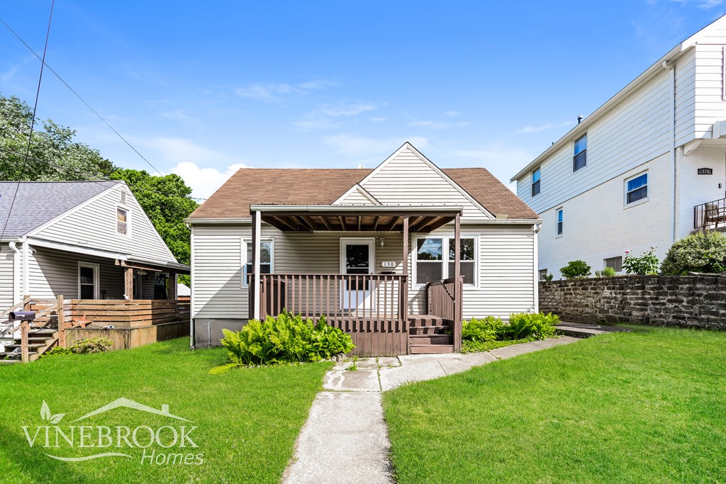 A Vinebrook Homes house with a front porch and a small garden.