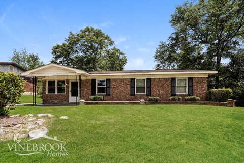 A house with a lawn in front of it.