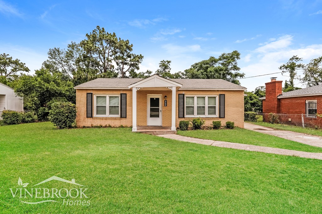 A house with a lawn in front of it and the words Vinebrook Homes on the bottom left.