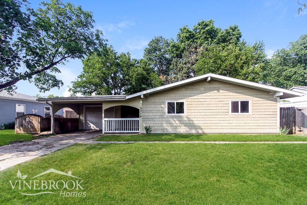 A house with a Vinebrook Homes sign in front of it.