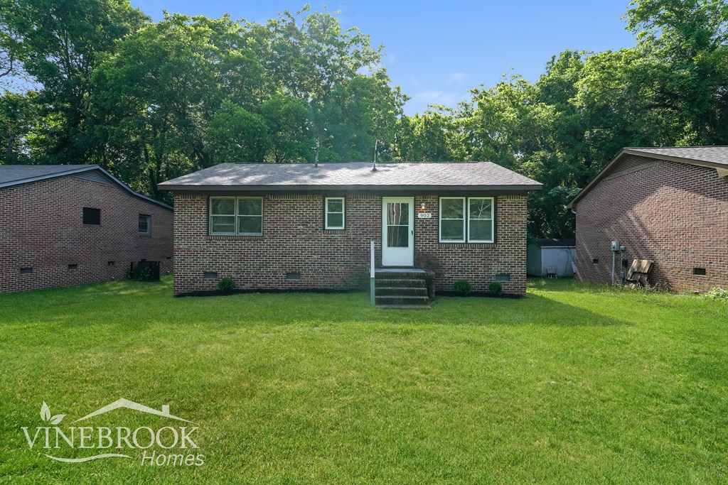 A house with a lawn in front of it and the words Vinebrook Homes on the bottom left.