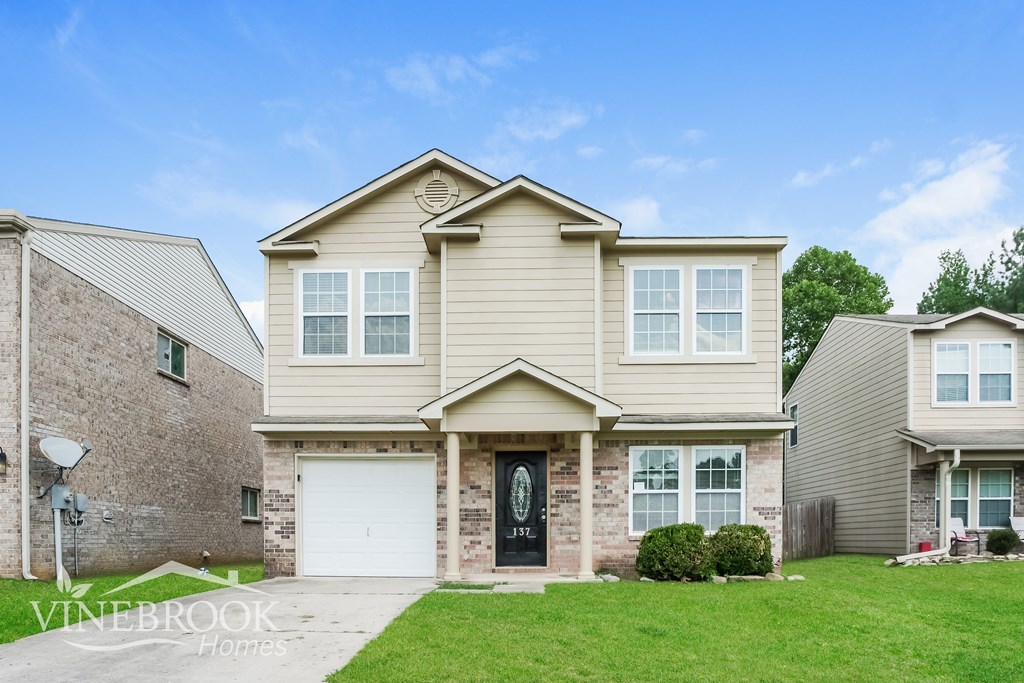 A house with a sign that says Vinebrook Homes.