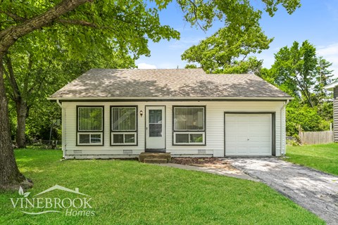 A house with a white garage door is for sale.
