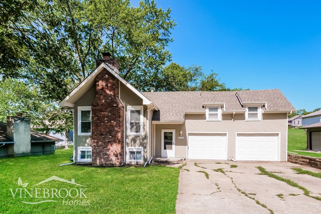 A house with a Vinebrook Homes sign in front of it.