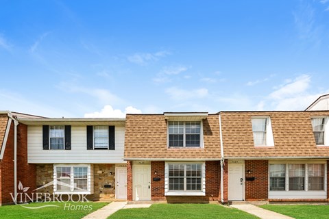 A Vinebrook Homes residential building with a clear blue sky above.