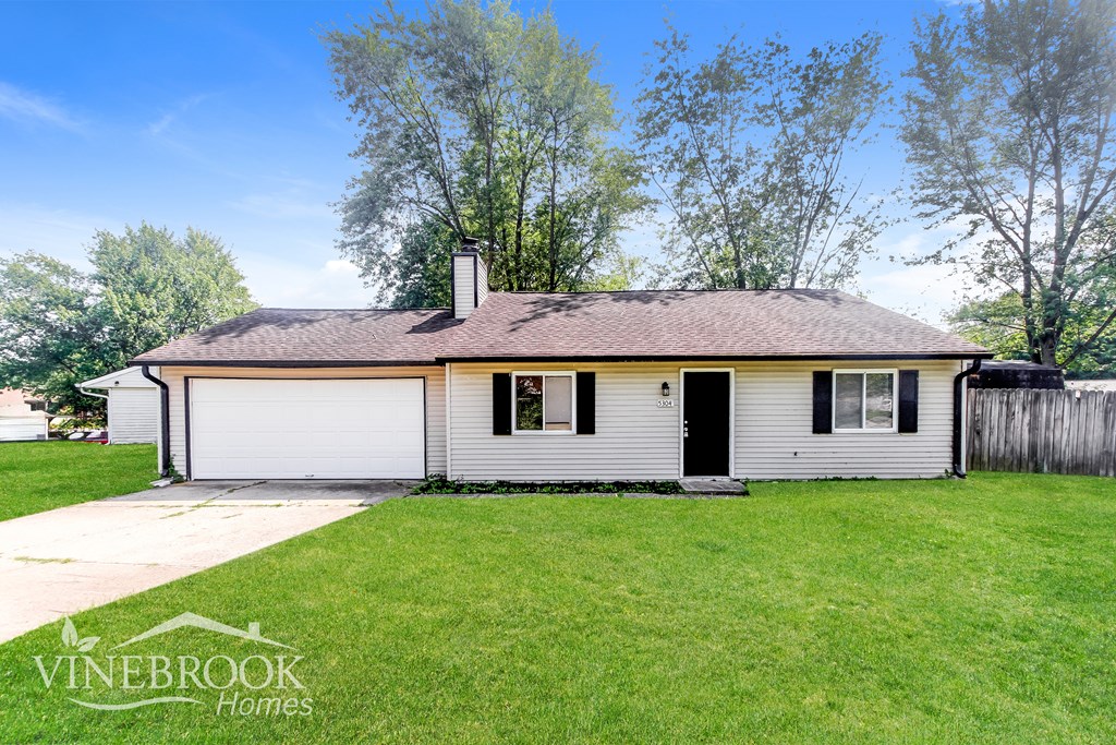 A house with a Vinebrook Homes sign in front of it.