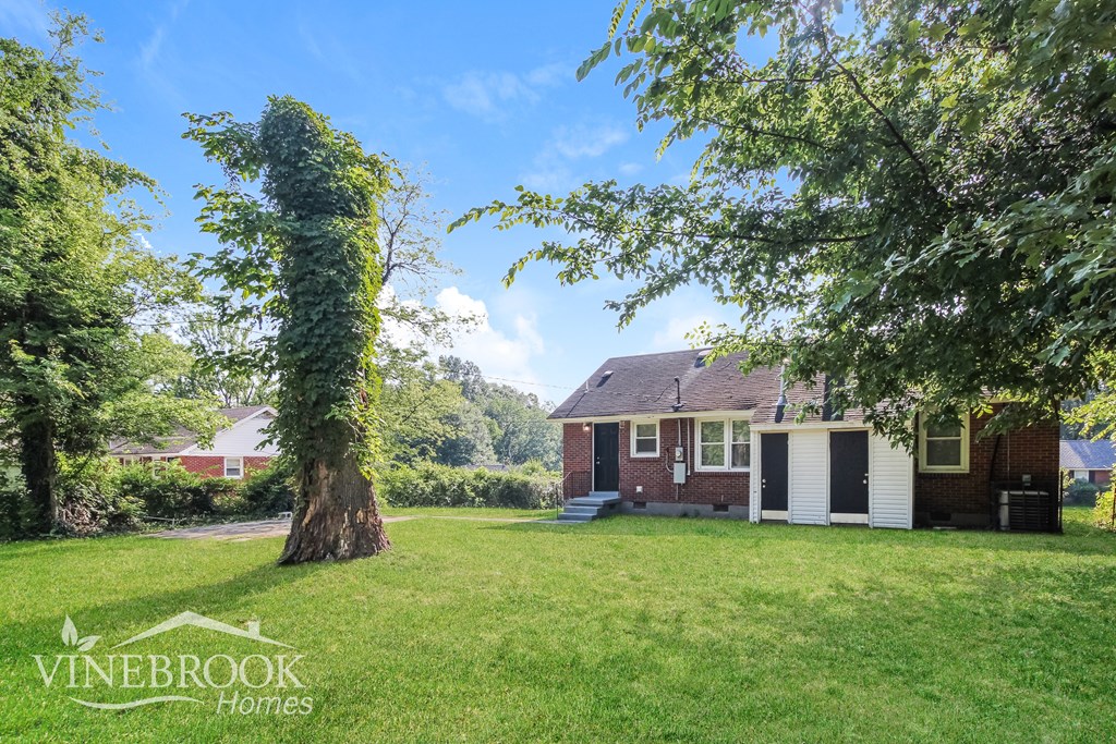 a home with a large yard and a large tree