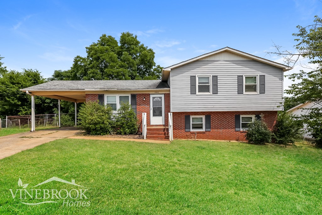 a brick and with a yard and a fence