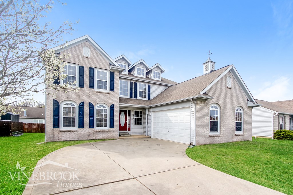 A house with a blue and white facade is for sale.
