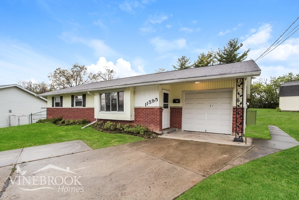 A house with a garage is for sale.