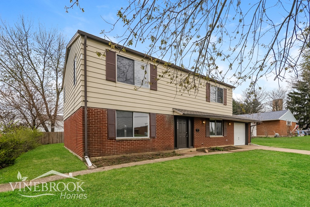 A house with a Vinebrook Homes sign in front of it.
