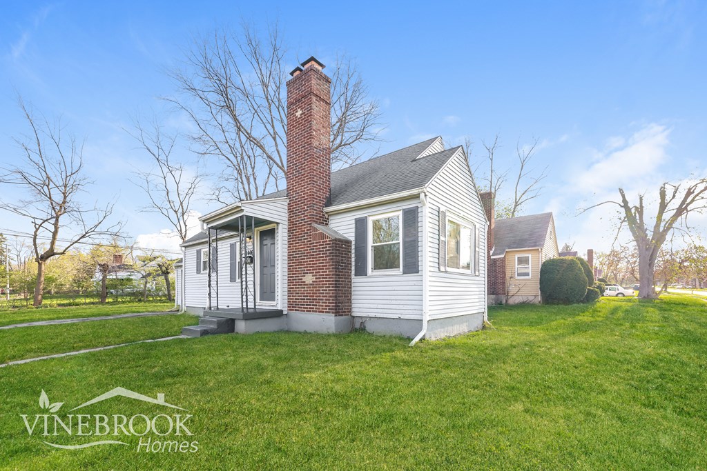 A house with a chimney is for sale by Vinebrook Homes.