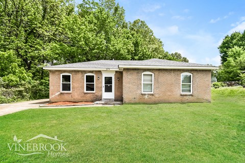 A house with a lawn in front of it.
