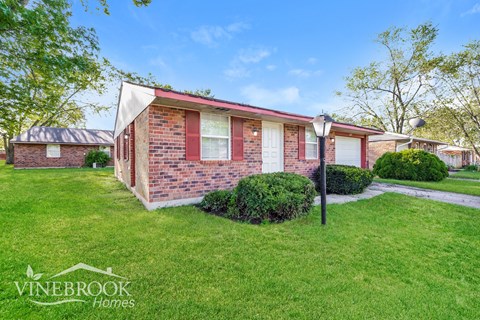 A house with a lawn in front of it.