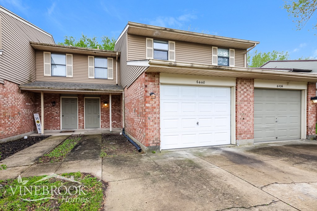 A two-story house with a garage is for sale.