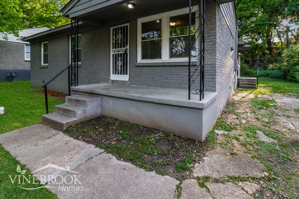 A house with a front porch and a staircase leading to it.