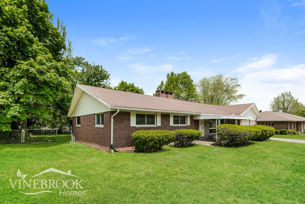 A house with a lawn in front of it and the words Vinebrook Homes on the bottom left.