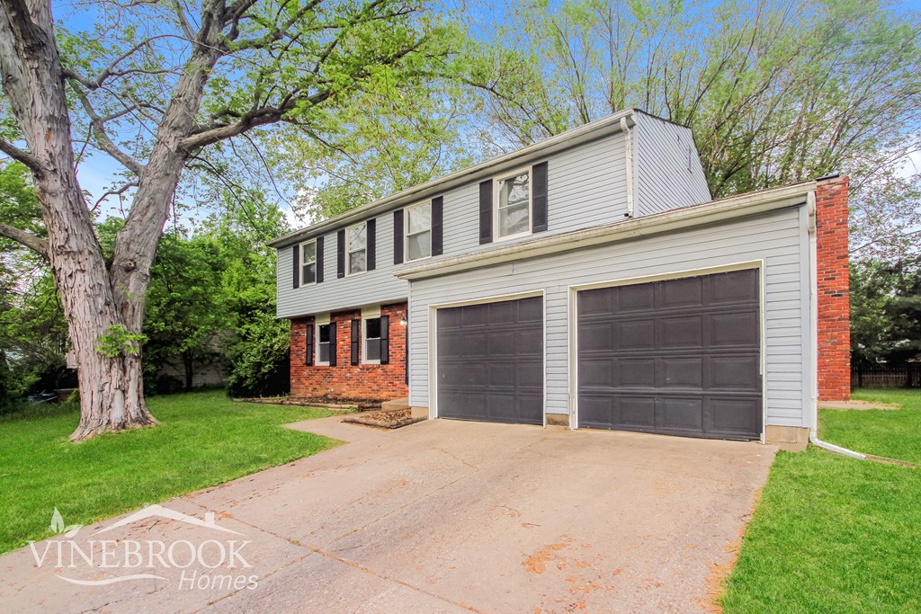 A two-car garage with a brick chimney is for sale.