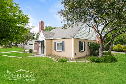 A house with a Vinebrook Homes sign in front of it.