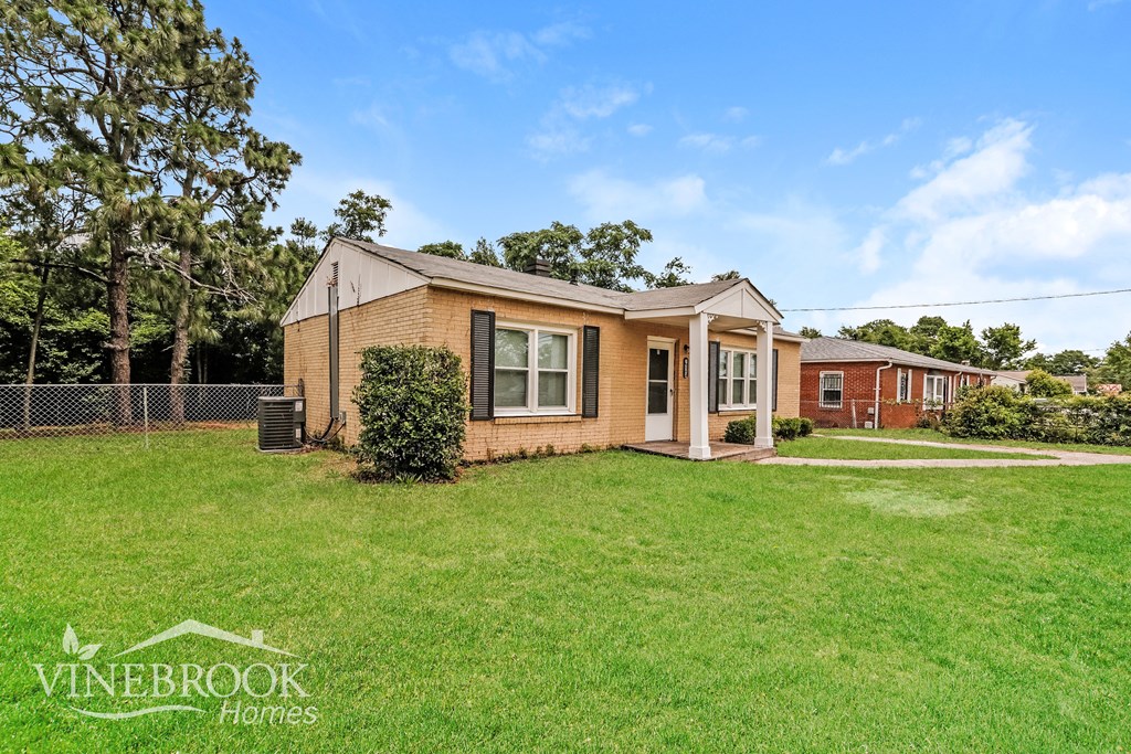 A house with a lawn in front of it is for sale.