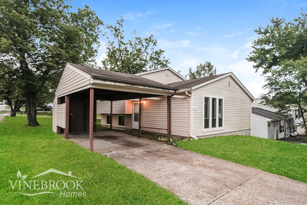 A house with a covered patio is for sale in Vinebrook Homes.