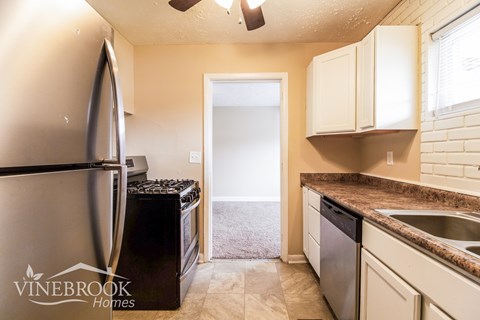 A kitchen with a Vinebrook Homes logo.