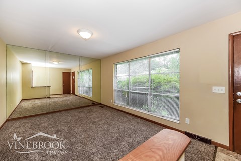 a living room with a large window and a couch