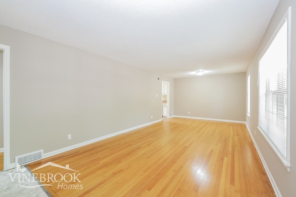 the living room and dining room with wood flooring