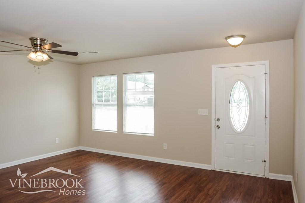 A room with a Vinebrook Homes logo on the floor.