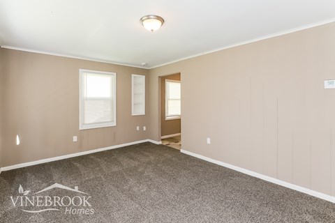 A room with beige walls and a carpeted floor.