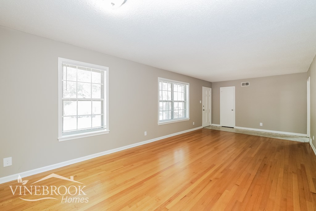 the living room of a house with a hardwood floor