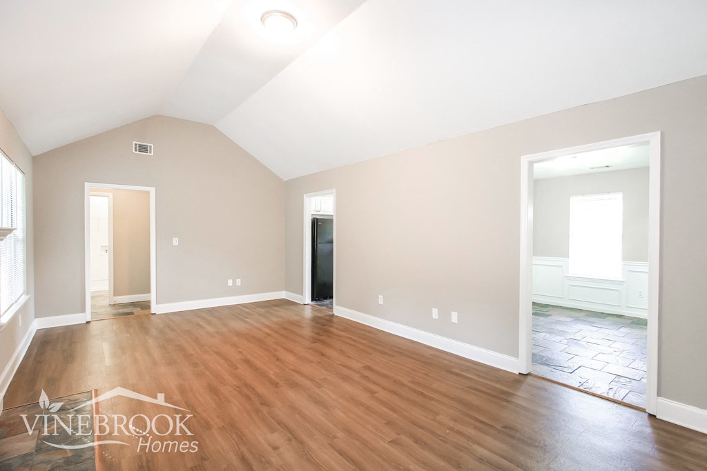 the living room and dining room with hardwood flooring