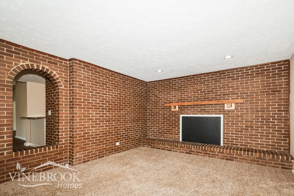 a room with a brick wall and a chalkboard
