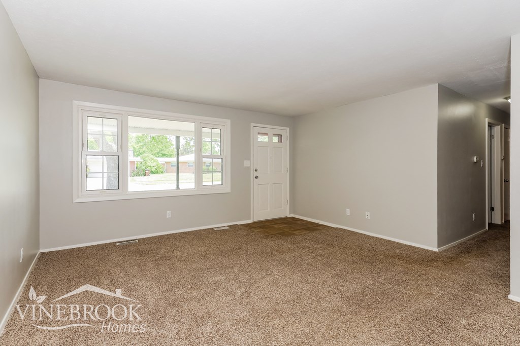 the master bedroom is spacious and clean with carpeting and a large window