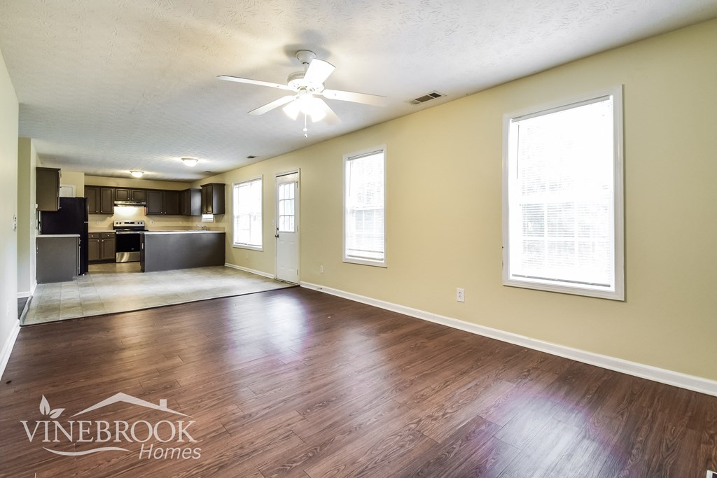 the living room and kitchen of an empty house