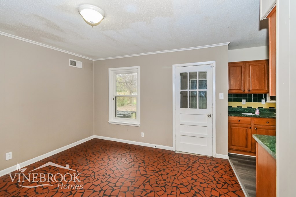 A room with a tiled floor and a window.