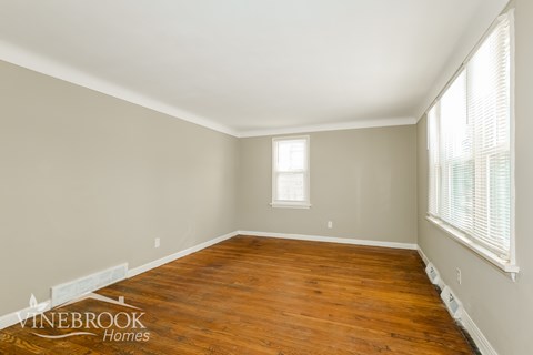 A room with wooden floors and a window.